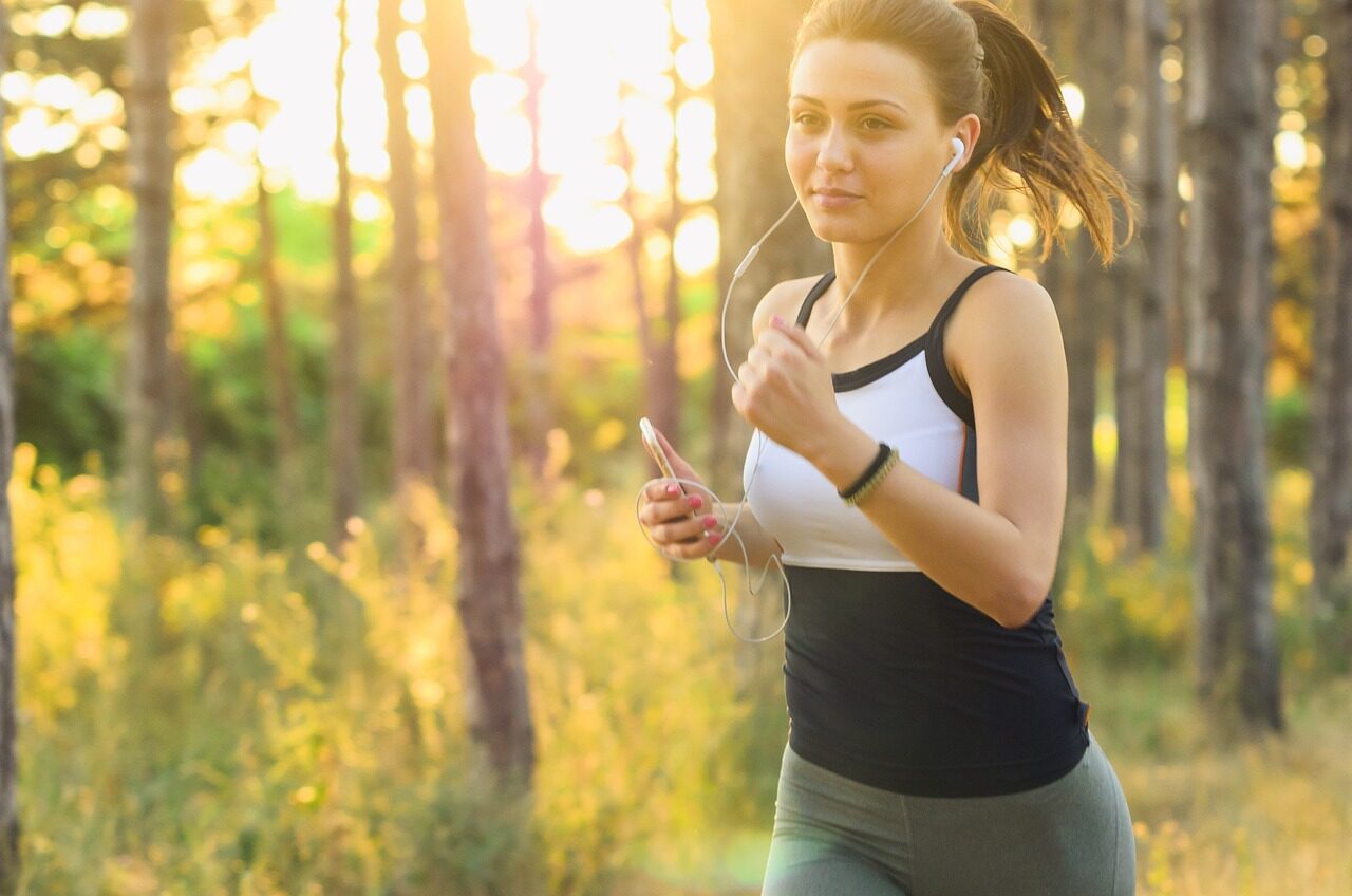 Woman running outdoors with healthy legs after varicose vein treatment